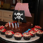Noah's pirate ship cake and pirate cupcakes made by his Grandmother!